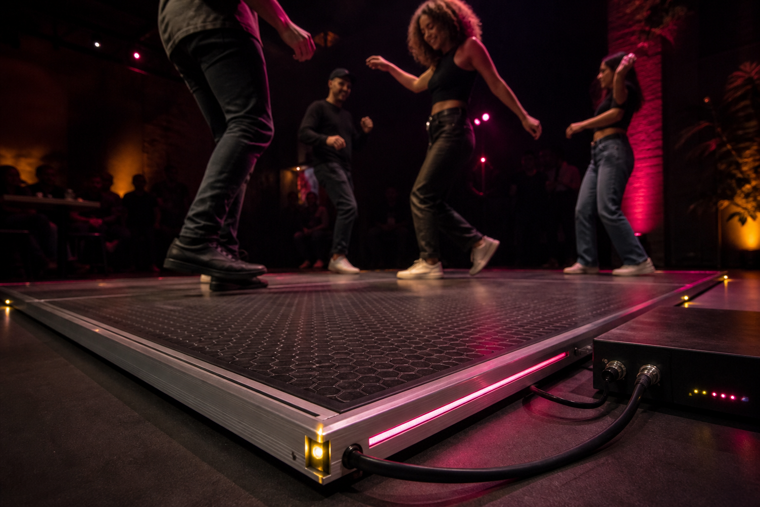 Haptic dance floor panel with dancers experiencing bass vibration at a silent event